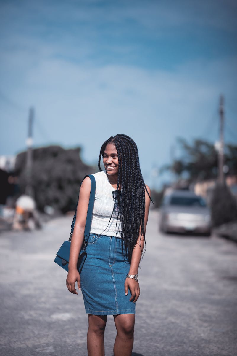 A Woman Wearing a Tank Top and a Denim Skirt
