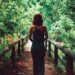 woman in black dress standing on bridge